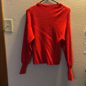 Cute red sweater.